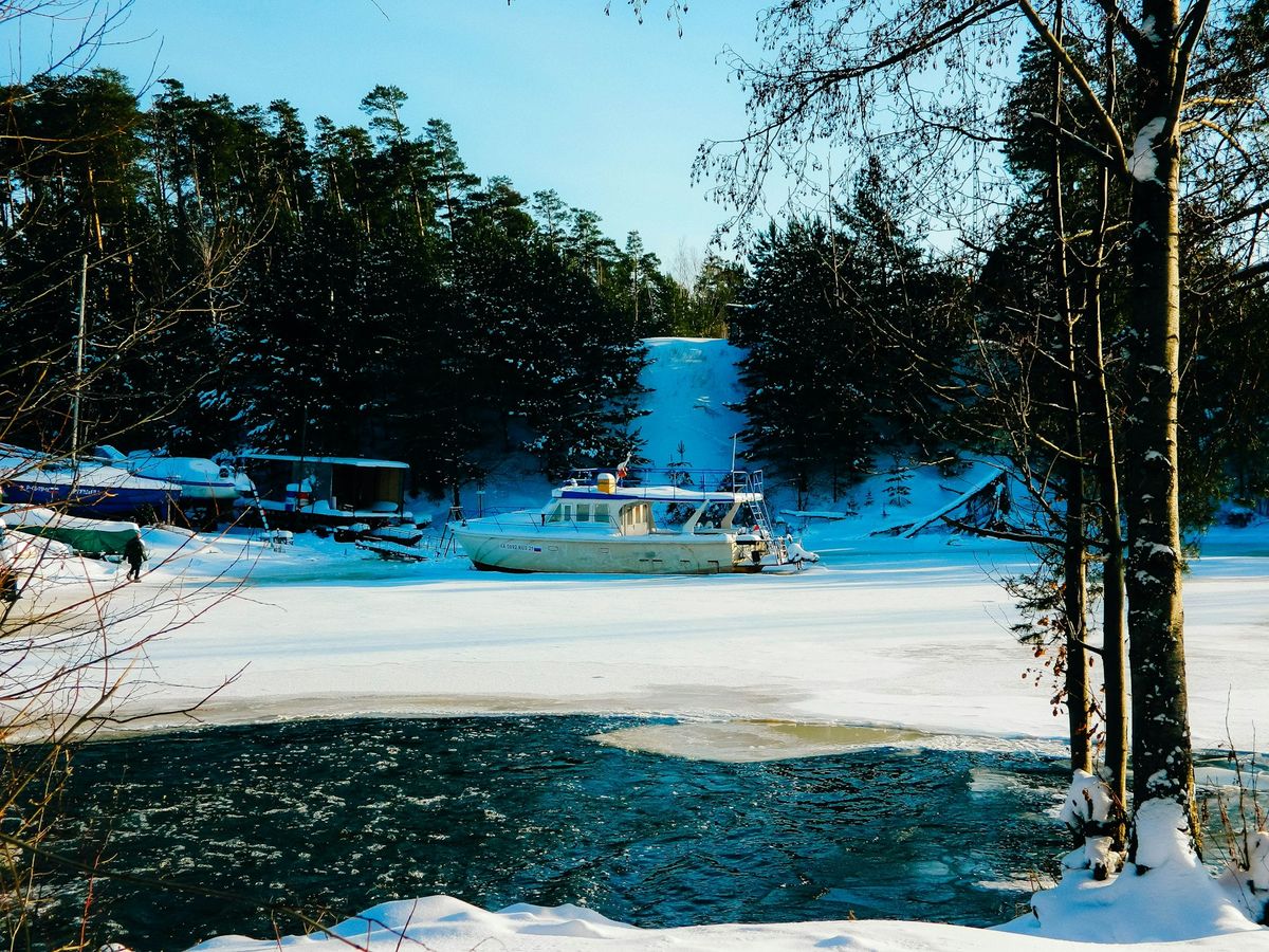 Boat on a frozen lake in the woods