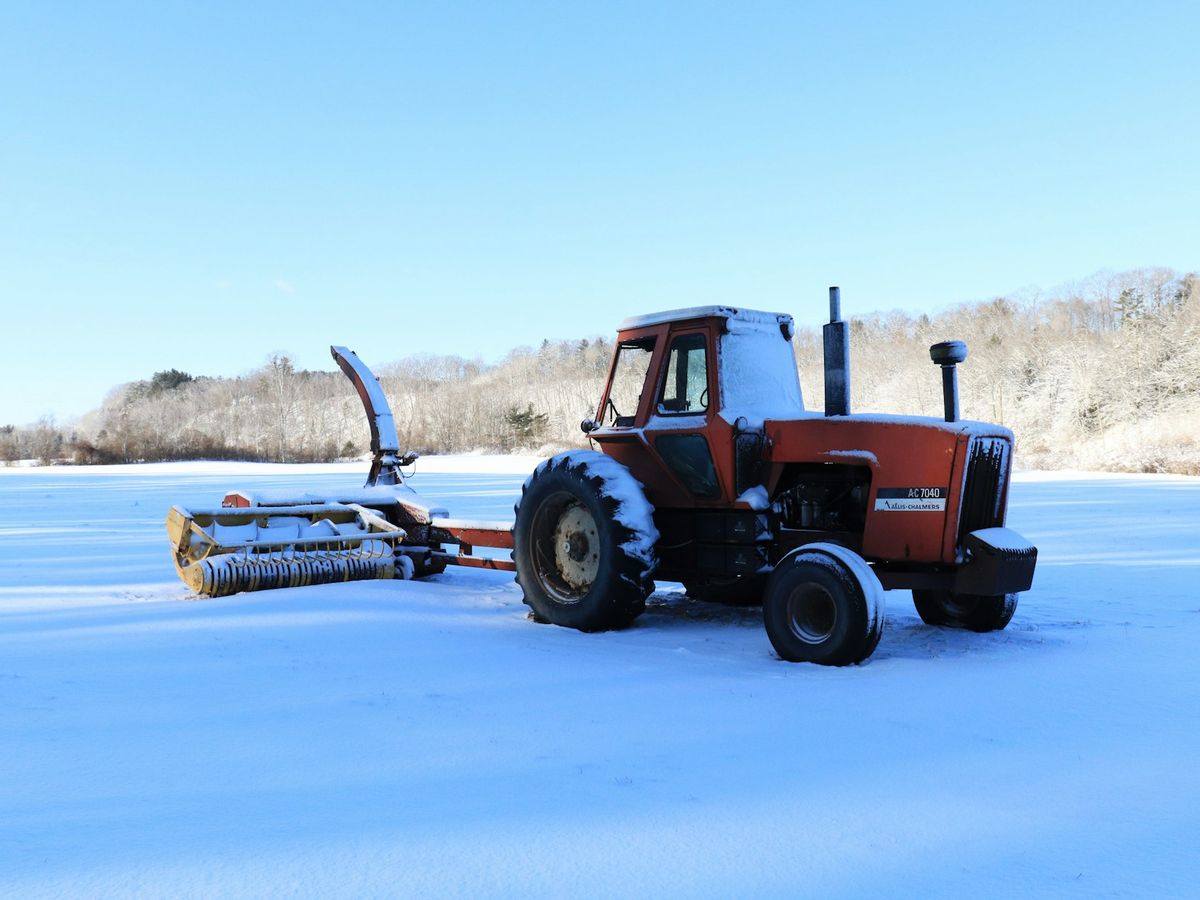 Tractor with a snow blower on a snowy field